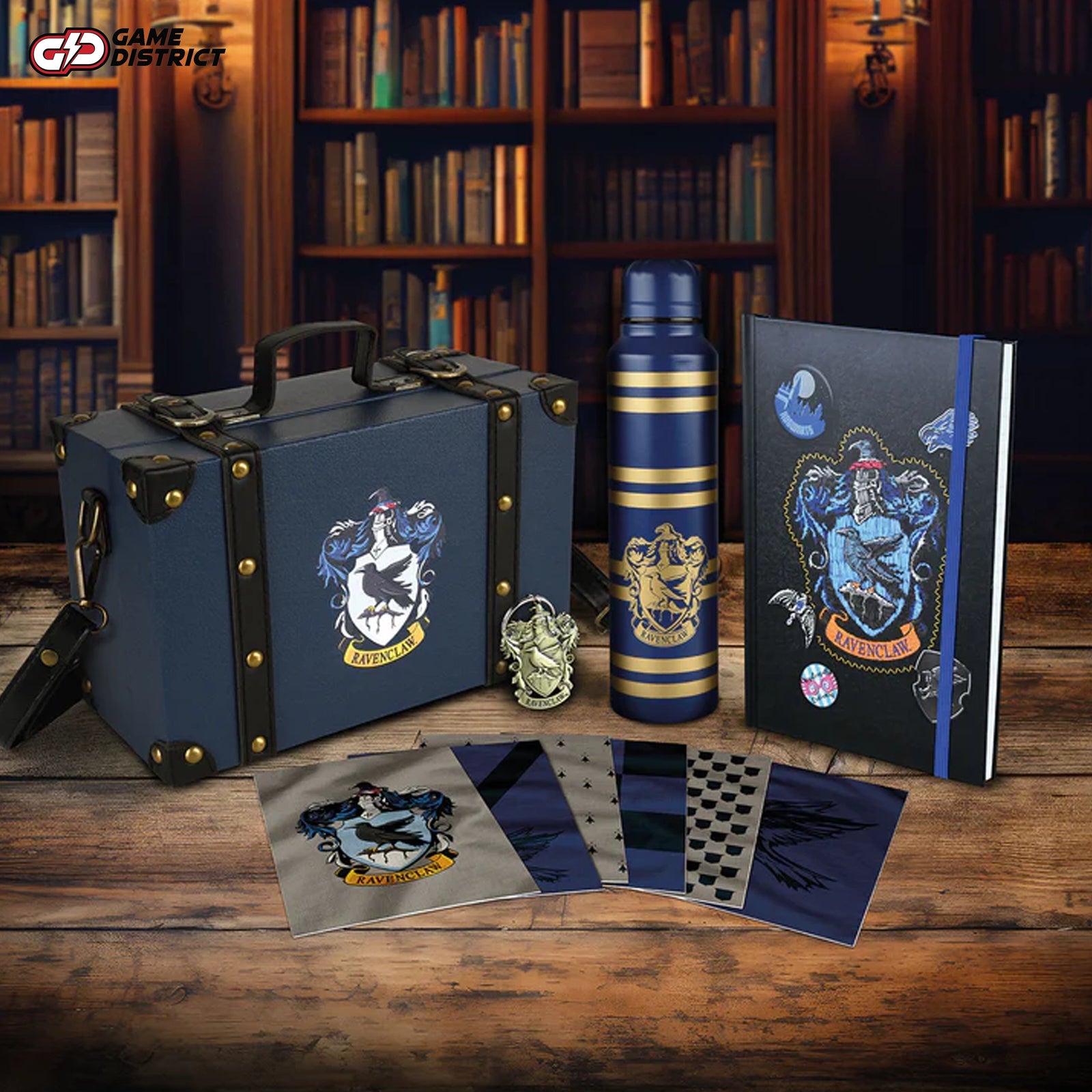 Harry Potter Ravenclaw House Deluxe Gift Collection featuring a themed trunk with a shoulder strap Premium A5 notebook with the Ravenclaw crest from the gift set for Harry Potter fans. Durable metal water bottle showcasing the Ravenclaw emblem, part of the deluxe collection Ravenclaw-themed keyring and postcards included in the Harry Potter gift set. Complete Ravenclaw Deluxe Gift Collection displayed with its themed trunk and accessories